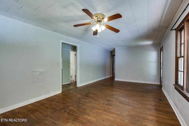 empty room featuring ceiling fan and dark wood-type flooring