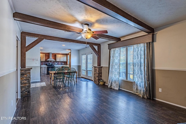 dining space with dark hardwood / wood-style flooring, ornamental molding, ceiling fan, a textured ceiling, and beam ceiling