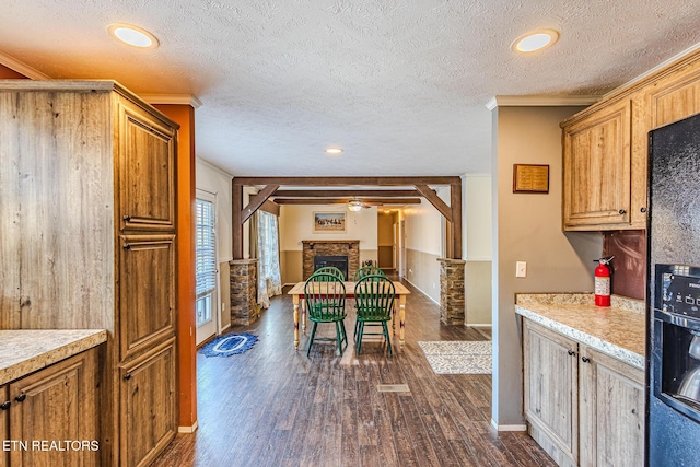 kitchen featuring ornamental molding, a textured ceiling, and dark hardwood / wood-style flooring