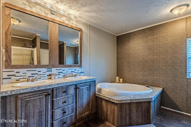 bathroom featuring tasteful backsplash, crown molding, separate shower and tub, a textured ceiling, and vanity