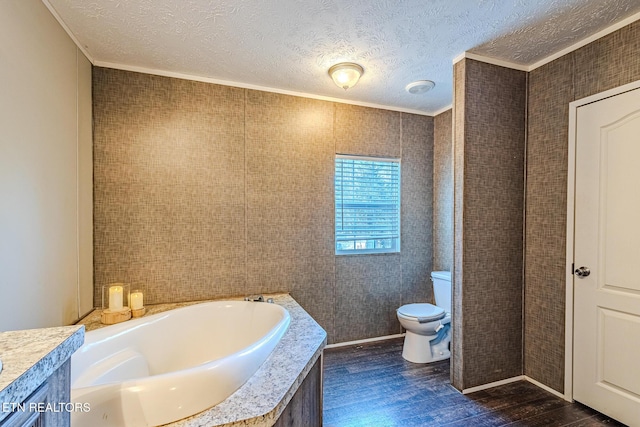 bathroom with hardwood / wood-style floors, ornamental molding, a textured ceiling, a tub, and toilet