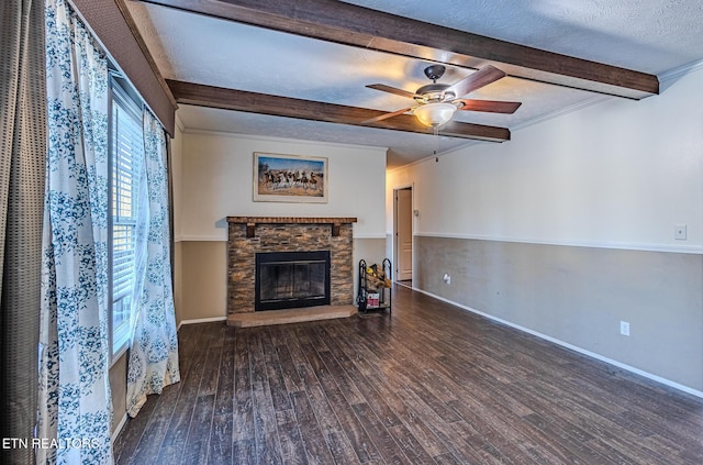 unfurnished living room with dark wood-type flooring, ornamental molding, a fireplace, and a textured ceiling