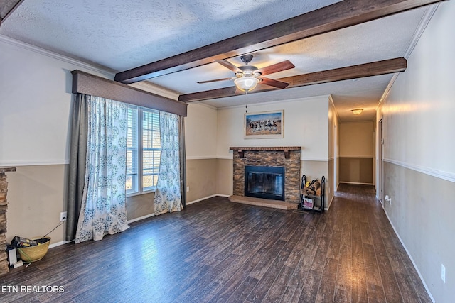 unfurnished living room featuring dark hardwood / wood-style floors, a fireplace, ceiling fan, a textured ceiling, and beam ceiling