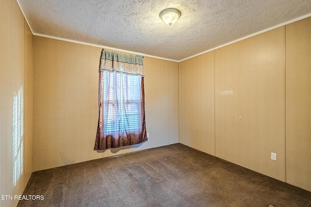 unfurnished room with crown molding, dark carpet, and a textured ceiling