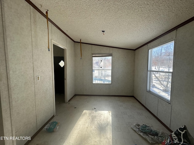 interior space with plenty of natural light, crown molding, and vaulted ceiling