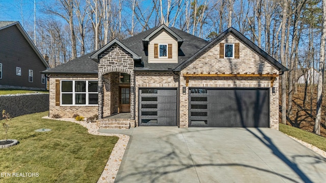 view of front of property with a front yard and a garage