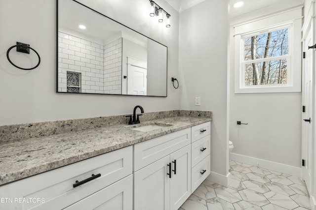 bathroom featuring vanity and toilet