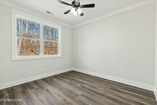 spare room featuring ceiling fan, ornamental molding, and dark wood-type flooring