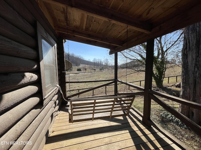 wooden deck with a rural view