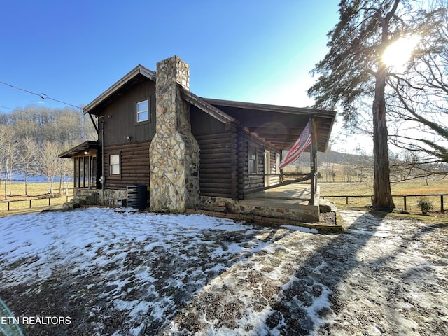 snow covered property featuring cooling unit