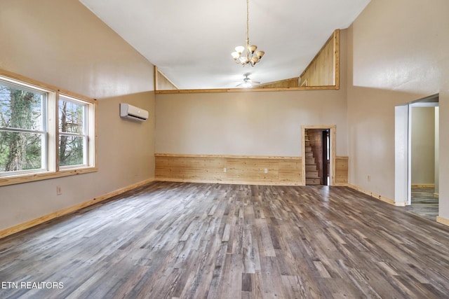 interior space with an AC wall unit, hardwood / wood-style flooring, high vaulted ceiling, and ceiling fan with notable chandelier