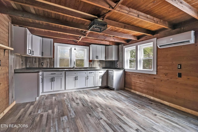 kitchen with wooden ceiling, hardwood / wood-style flooring, wooden walls, and a wall mounted air conditioner