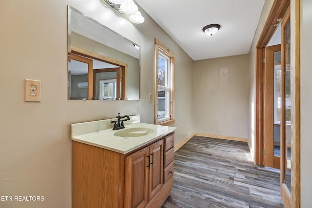 bathroom with vanity, a textured ceiling, and hardwood / wood-style floors