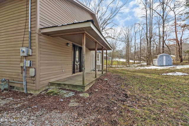 view of side of home with a shed