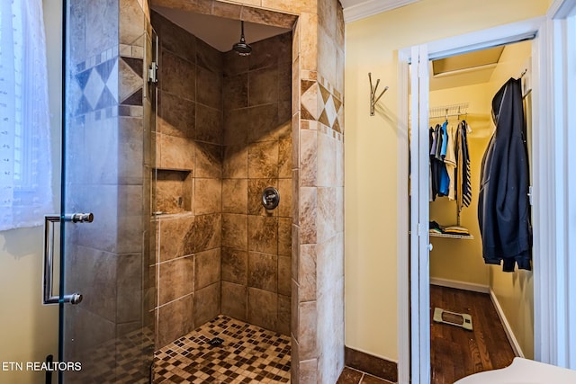 bathroom featuring walk in shower and crown molding