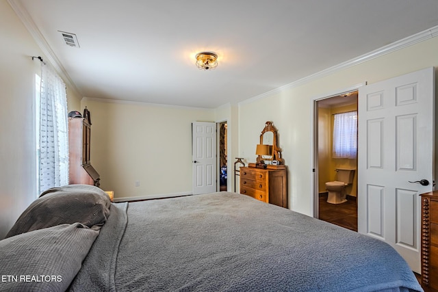 bedroom featuring crown molding and ensuite bath