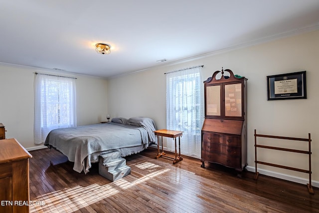 bedroom featuring dark hardwood / wood-style flooring and ornamental molding