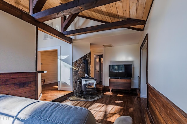 living room featuring beam ceiling, a wood stove, high vaulted ceiling, dark hardwood / wood-style flooring, and wooden ceiling