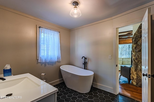 bathroom featuring a washtub and vanity