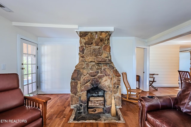 living room featuring wood-type flooring and a fireplace