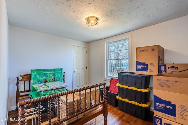 bedroom featuring a textured ceiling and hardwood / wood-style flooring