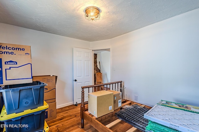 bedroom with dark hardwood / wood-style floors