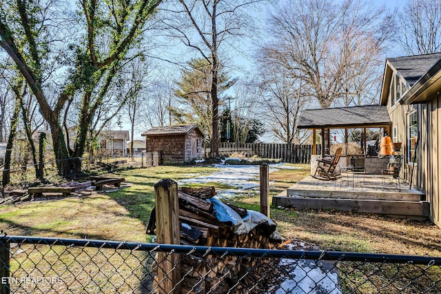 view of yard with a wooden deck and a storage unit