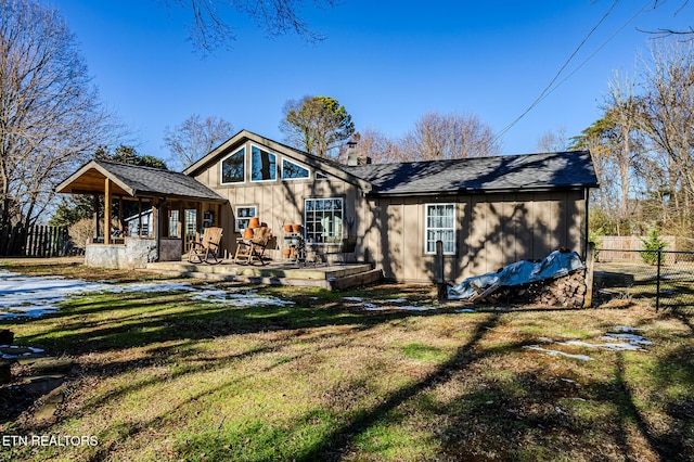 rear view of property with a patio area and a yard