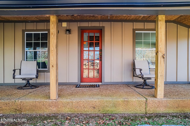 view of exterior entry featuring covered porch