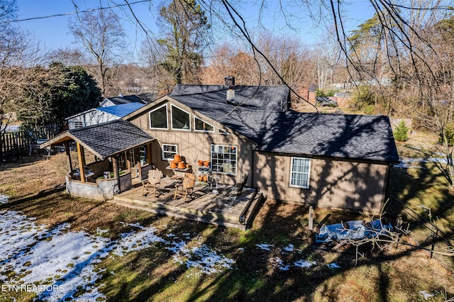 view of snow covered back of property