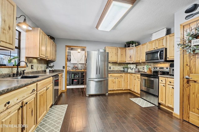 kitchen featuring backsplash, sink, dark wood-type flooring, appliances with stainless steel finishes, and light brown cabinets