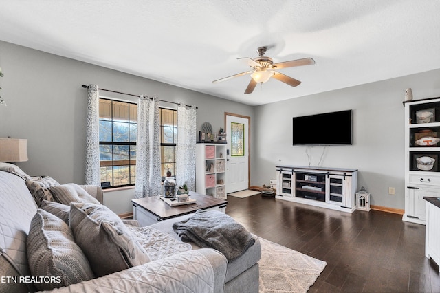 living room with ceiling fan, dark wood-type flooring, and a textured ceiling