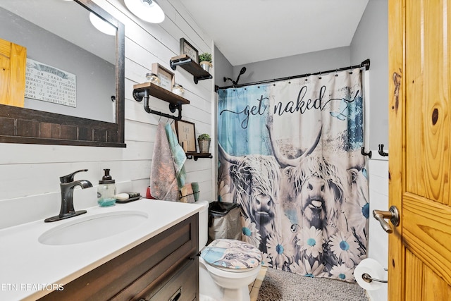 bathroom featuring curtained shower, toilet, vanity, and wood walls