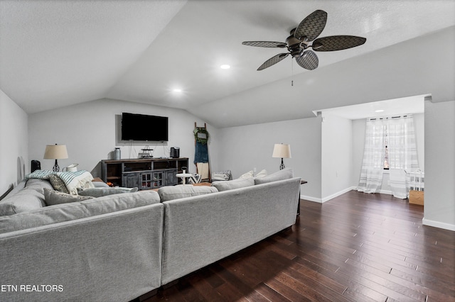 living room with lofted ceiling, ceiling fan, and dark hardwood / wood-style floors