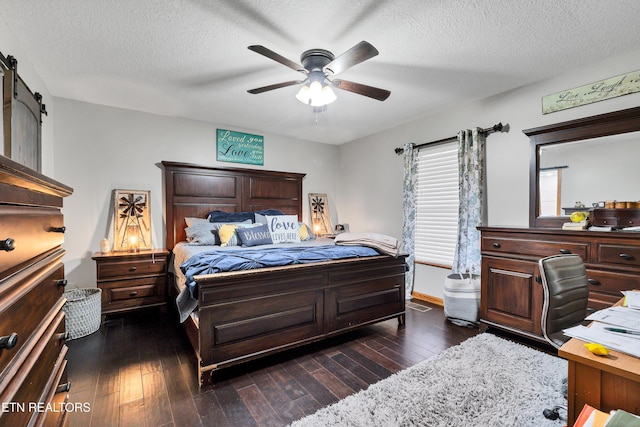 bedroom featuring ceiling fan, dark hardwood / wood-style floors, and a textured ceiling