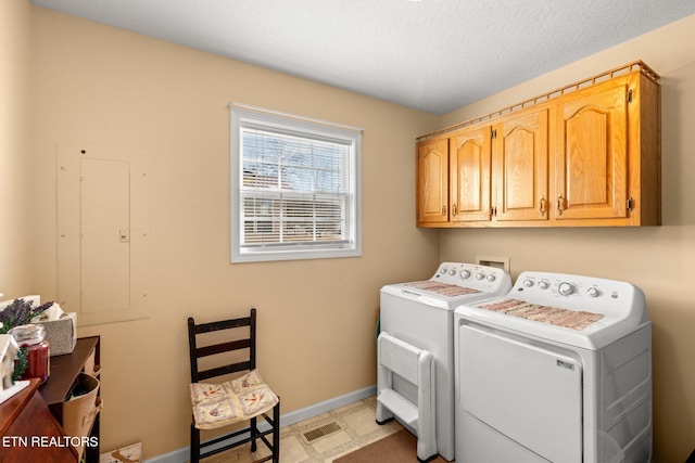 laundry room with cabinets and washer and dryer