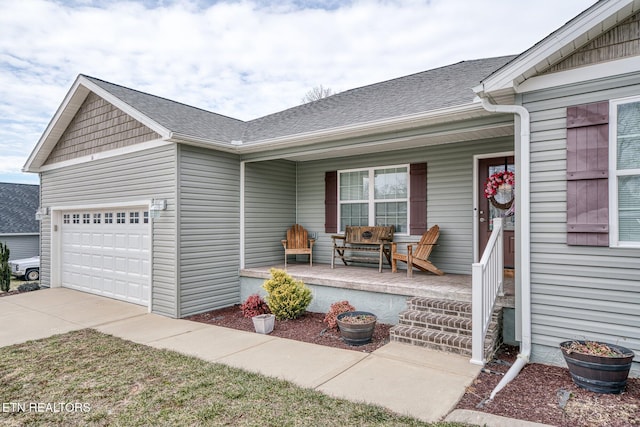 entrance to property featuring covered porch and a garage