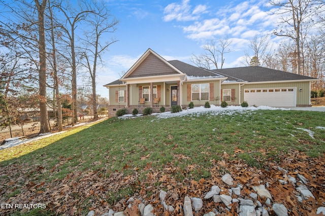 craftsman inspired home with a garage, a front lawn, and a porch