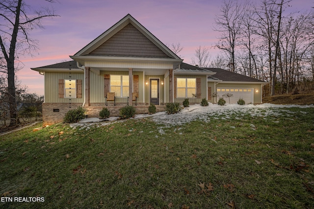 craftsman house featuring a garage, a yard, and covered porch