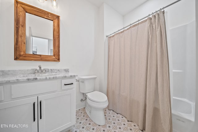 bathroom with toilet, vanity, tile patterned floors, and walk in shower