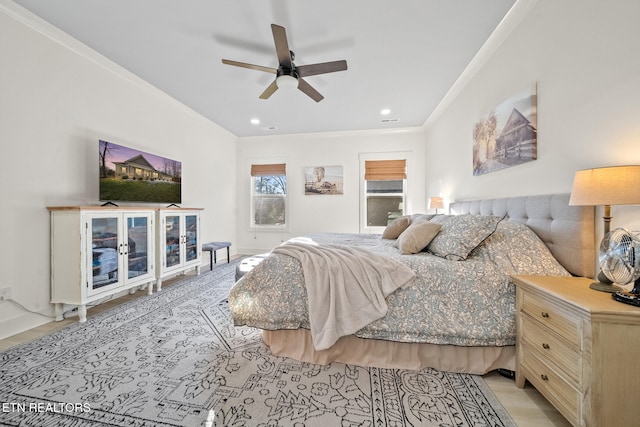 bedroom with ceiling fan and crown molding