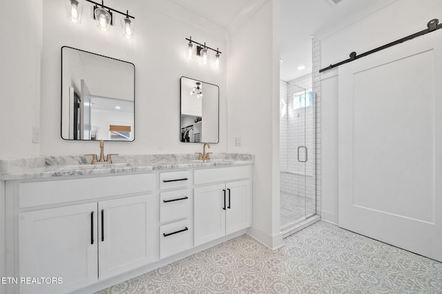 bathroom featuring vanity, tile patterned flooring, ornamental molding, and a shower with door