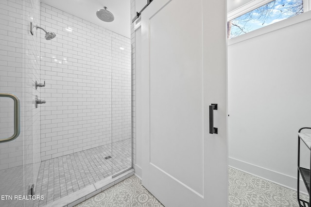 bathroom with tile patterned flooring and a shower with shower door