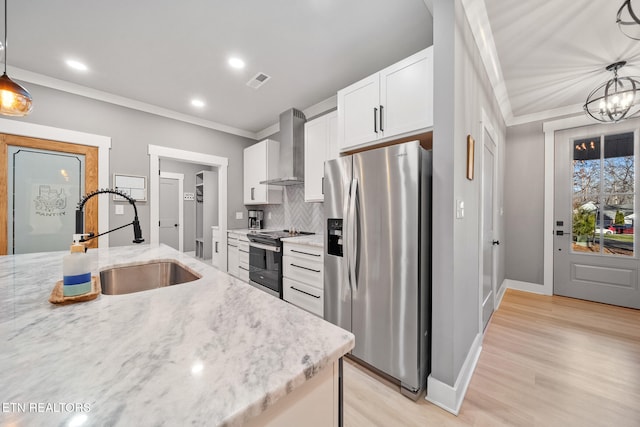 kitchen with wall chimney range hood, electric range oven, pendant lighting, sink, and stainless steel fridge with ice dispenser