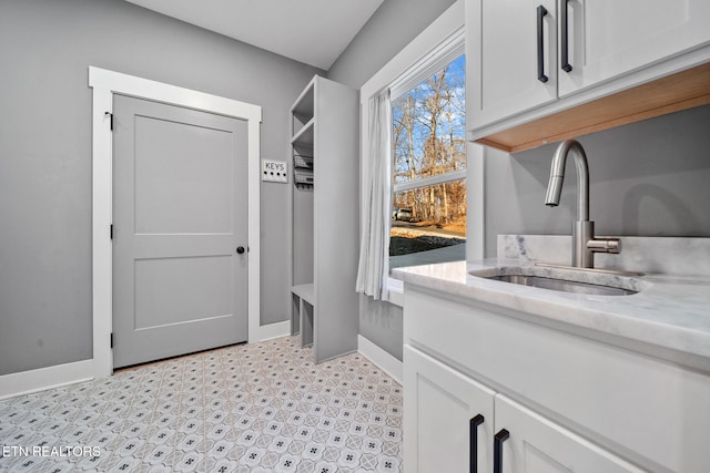 washroom with cabinets and sink