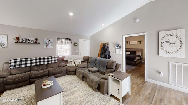 living room with lofted ceiling and light hardwood / wood-style flooring