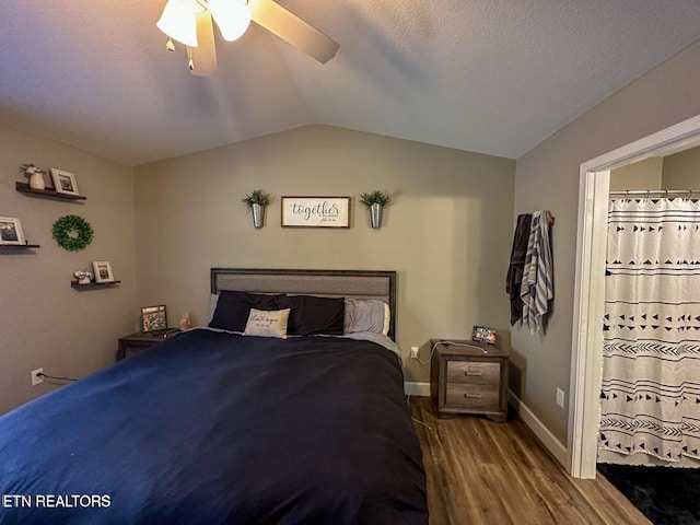 bedroom featuring ceiling fan, lofted ceiling, dark hardwood / wood-style flooring, and a textured ceiling