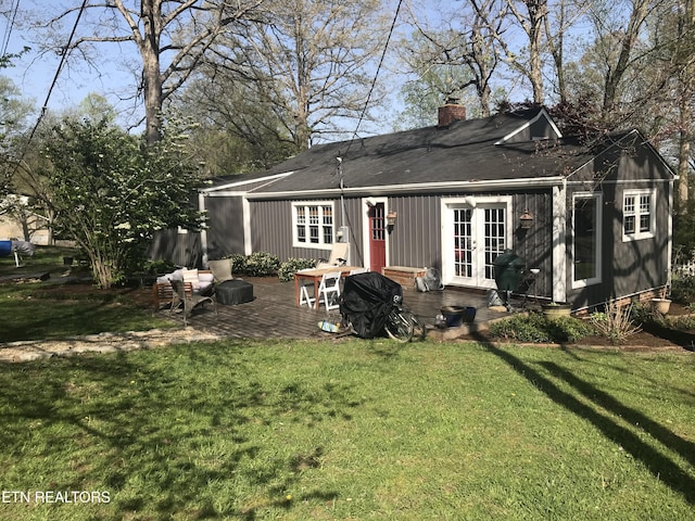 rear view of house with a yard and a patio