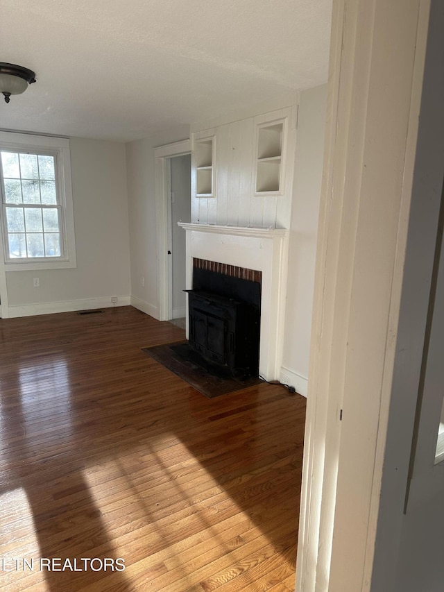 unfurnished living room with wood-type flooring