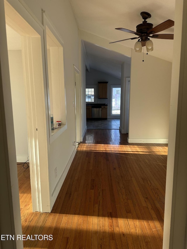 hallway featuring dark hardwood / wood-style floors and lofted ceiling